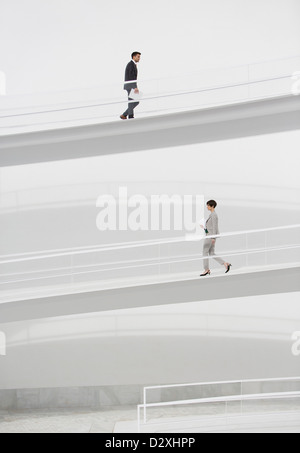 Business people walking on elevated walkways Stock Photo