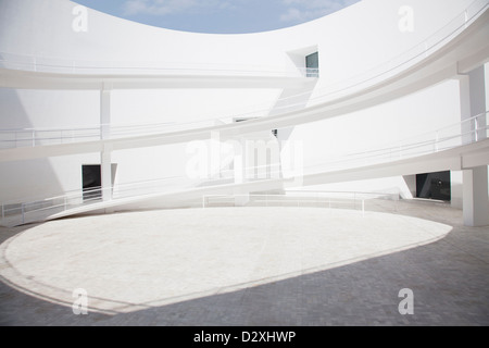 Businessman walking through modern courtyard Stock Photo