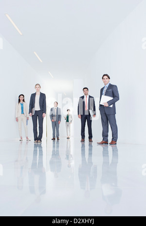 Portrait of confident business people in corridor Stock Photo