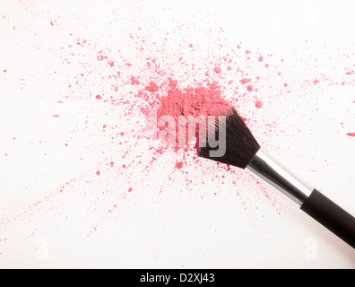 Makeup brush and pink blush powder splatter Stock Photo