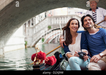 Smiling couple riding in gondola in Venice Stock Photo