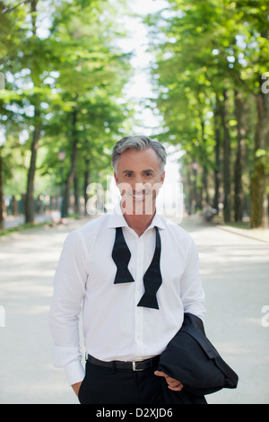 Portrait of well-dressed man in park Stock Photo