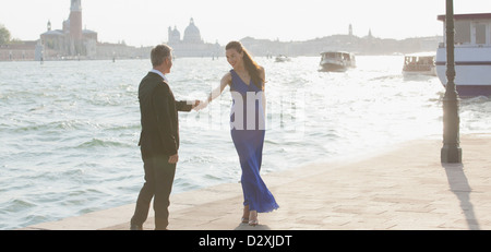 Well-dressed man and woman at waterfront in Venice Stock Photo