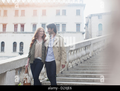 Smiling couple descending stairs in Venice Stock Photo