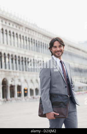 Portrait of smiling businessman in St. Mark’s Square in Venice Stock Photo