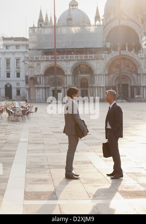 Businessmen talking in St. Mark's Square in Venice Stock Photo