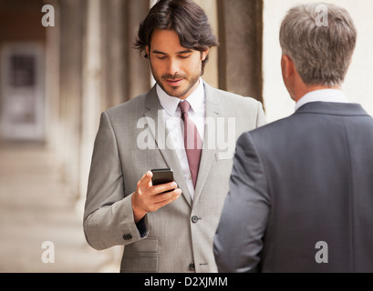 Businessman checking cell phone Stock Photo