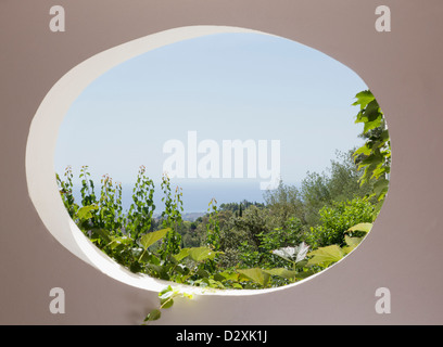 View of garden through oval window Stock Photo