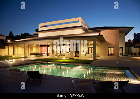 Luxury house and swimming pool illuminated at night Stock Photo