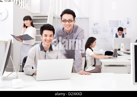 Busy office workers in studio Stock Photo