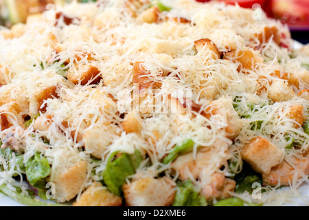 Caesar salad on a plate sprinkled with grated cheese Stock Photo
