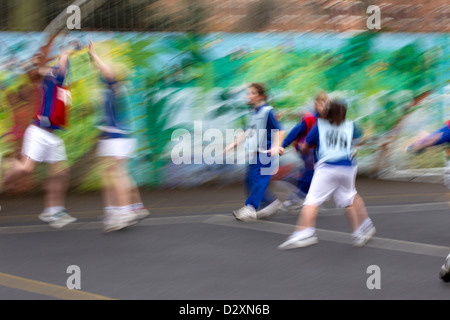 primary school children playing netball match in school playground Stock Photo