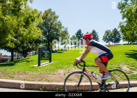 A cyclist in Confluence Park on the Platte River Trail in Denver, Colorado Stock Photo