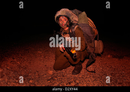 An Israeli female soldier from the 727th Eitam Field Intelligence Battalion of the Combat Intelligence Collection Corps during advance training at night close to the border with Egypt in the southern Negev desert Israel Stock Photo