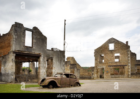 the French village Oradour-sur-Glane. It has been preserved In a Ruined State, buildings and car seen here destroyed by fire. Stock Photo