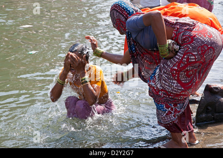 Women bathing in the sacred waters of the Ganges river. Varanasi, India ...