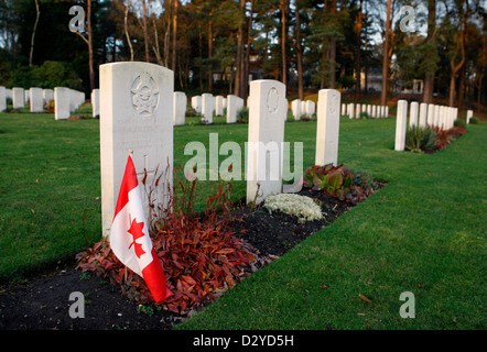 A Canadian flag sits beside a miltary grave at Brookwood Military Cemetery. The burial ground is the largest cemetery in the UK Stock Photo