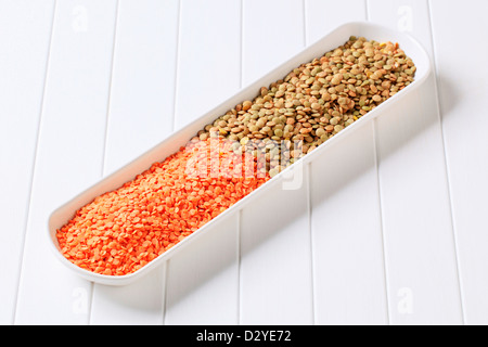 Raw red and brown lentils in a long dish Stock Photo