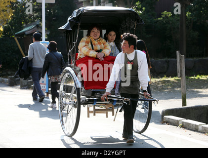 Kamakura, Japan, women are sitting in a rickshaw Stock Photo