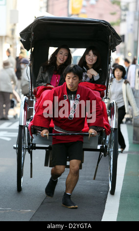 Kamakura, Japan, women are sitting in a rickshaw Stock Photo