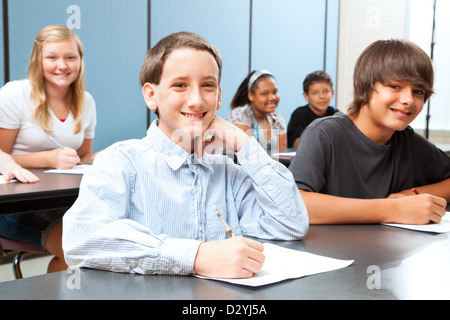 Cute boy in middle school class taking a test.  Stock Photo