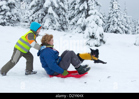 mother and son sledding on Sonnenberg near St. Andreasberg, Harz Mountains, Lower Saxony, Germany Stock Photo