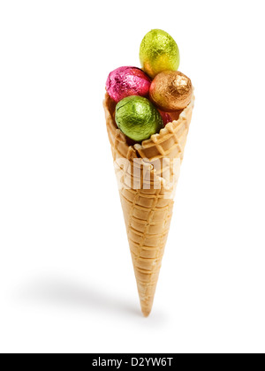 Waffle cone with colorful chocolate candy Easter eggs wrapped in foil Stock Photo