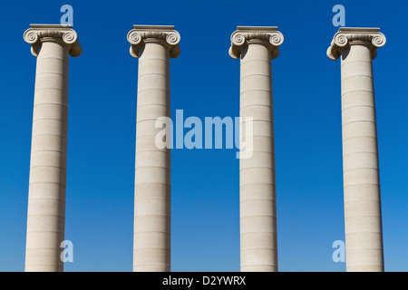 Four massive columns, blue sky Stock Photo