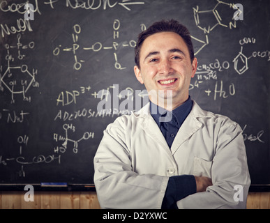 chemistry teacher and blackboard background Stock Photo