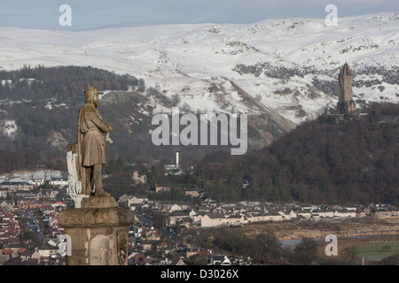 Outside Stirling Castle stands the statue of Robert The Bruce, overlooking Stirling, with William Wallace monument in distance. Stock Photo