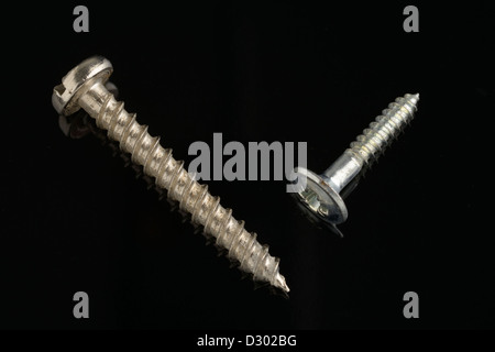 two screws on black background Stock Photo
