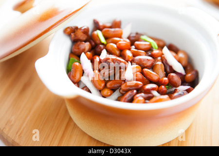 boiled beans in a pot on a wooden surface, closeup Stock Photo