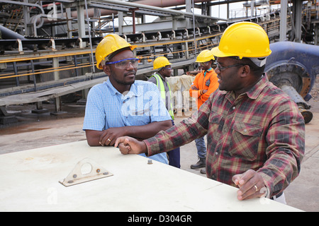 Four FQM employees having a discussion Stock Photo