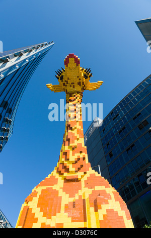A figure of a giraffe in front of LEGO in the Legoland Discovery Centre in the Sony Center on Potsdamer Platz Stock Photo