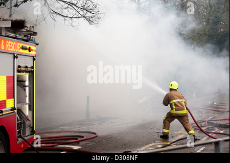 Firefighter tackles a blaze in England, UK Stock Photo