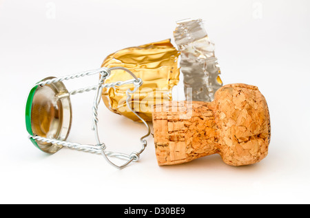 Sparkling wine cork with wire tie and gold foil on white background Stock Photo