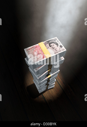 Large stack of £50 pound British bank notes on plain background with ...