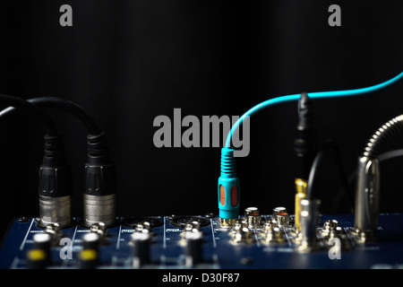 Color shot of many jacks plugged in a mixer Stock Photo