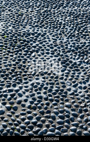 Cobble stones laid in a pattern on a road surface. made from round flints Stock Photo