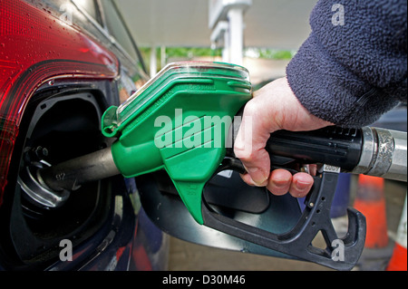 a customer filling a car with unleaded petrol Stock Photo