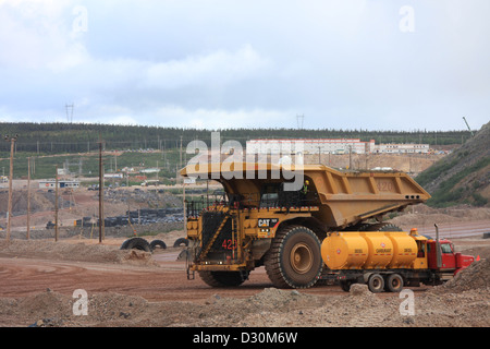 Huge trucks in the biggest Canadian open pit iron mine in Fort Wright Next to Fermont Caniapiscau Northeastern Quebec Canada Stock Photo