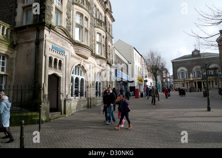 People on a Saturday walking along a street in Guildhall Square Carmarthen, Carmarthenshire, Wales, UK  KATHY DEWITT Stock Photo