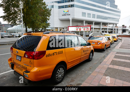 row of yellow cabs outside canada place Vancouver BC Canada Stock Photo