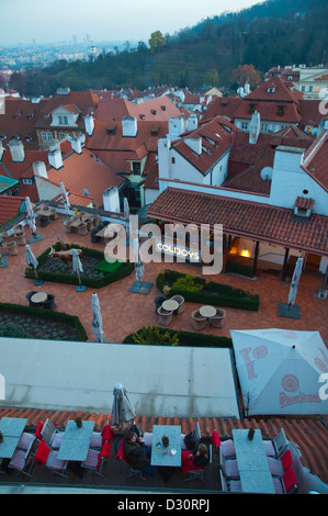 People dining on rooftop restaurant below Hrad the castle with views over Mala strana the little town historical quarter Prague Stock Photo