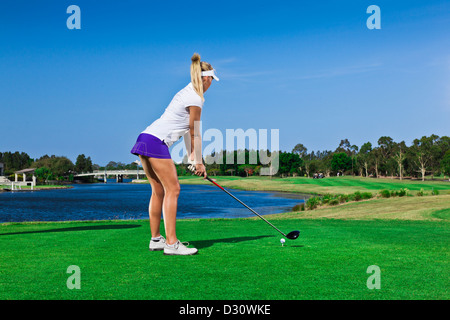Attractive golfer girl on golf course with driver Stock Photo - Alamy