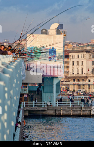 ISTANBUL TURKEY - Fishermen and fishing rods on the Galata Bridge with Galata Tower in background, Eminonu, Golden Horn, Bosphorus Stock Photo