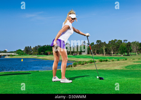 Attractive golfer girl on golf course with driver Stock Photo - Alamy