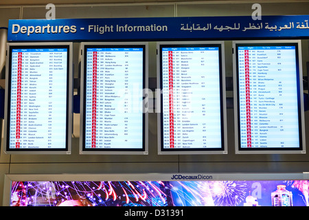 The flight information departure display at the terminal of the Dubai International Airport Stock Photo