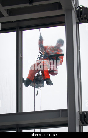 London City The Shard abseiling window cleaner outside 69th floor viewing deck cleaning windows with brush & squeegee 11,000 panes maintenance team Stock Photo