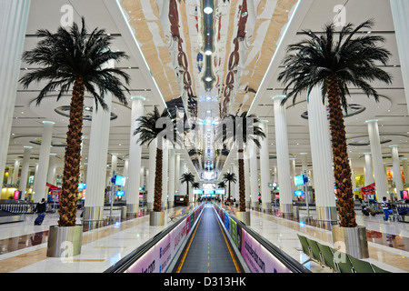 Palm trees line the walkway at the arrival and departure terminal of the Dubai International Airport Stock Photo